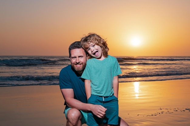 Father and son hugging on beach sunset family hug at sunrise sea