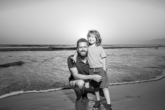 Father and son hugging each other at the seaside beach during sunset