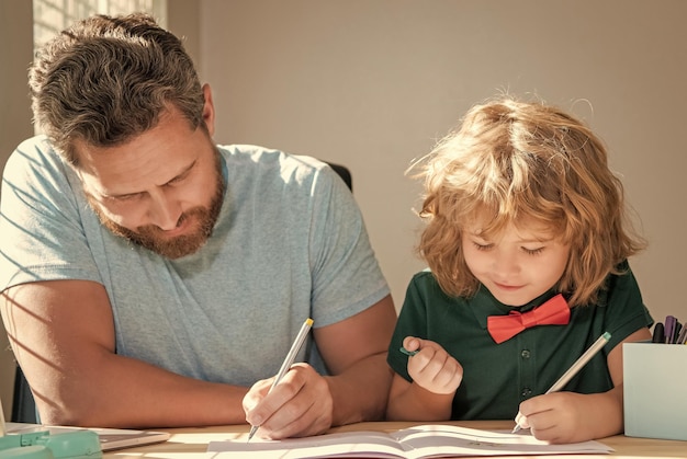 Photo father and son painting at home family help boy do homework with teacher