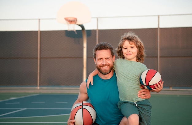 Father and son playing basketball Family leisure activities concept Dad and child boy spending time together playing basketball Sport family