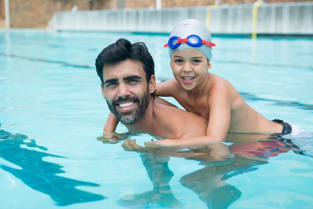 Father and son playing in pool