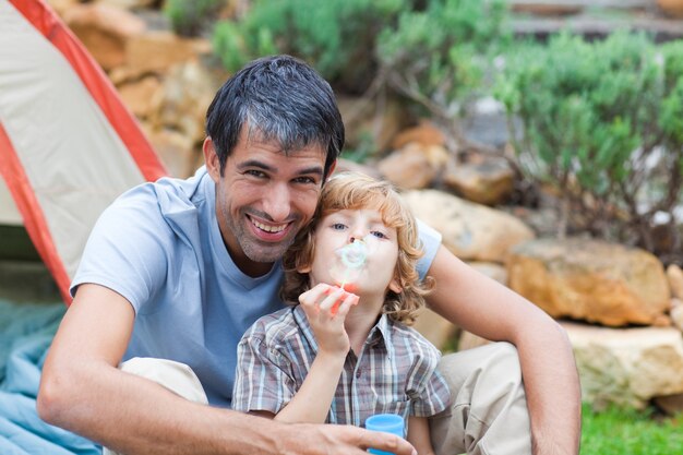 Father and son playing in a tent