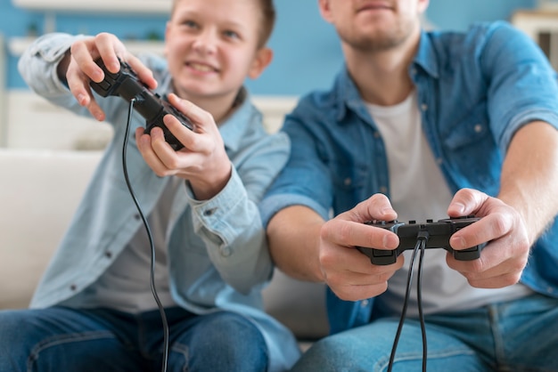 Photo father and son playing video games