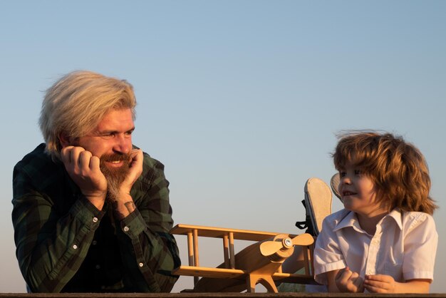 Father and son playing with toy plane outdoor Family holiday parenthood Fathers day