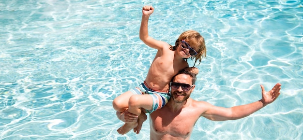 Father and son in pool Pool resort Boy with dad playing in swimming pool Active lifestyle concept Fathers Day Banner for header copy space Poster for web design