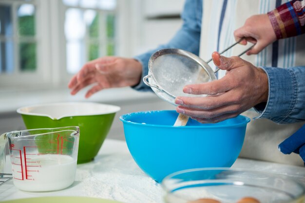 Father and son preparing cupcake