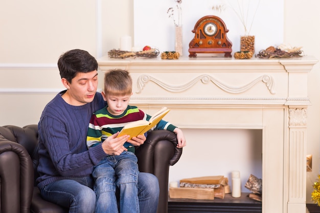 Father and son reading story book together