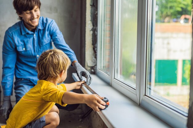 Father and son repair windows together Repair the house yourself