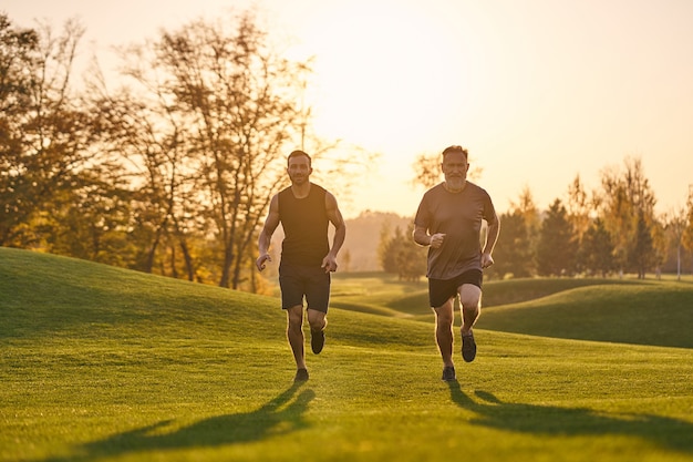 The father and son running in the beautiful park