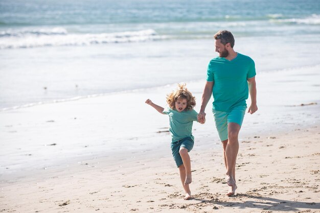 Father and son running on sea man famile relations concept