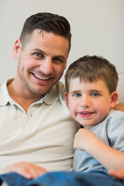 Father and son smiling together at home