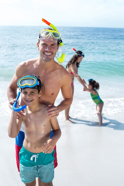 Father and son standing with mother and daughter at beach