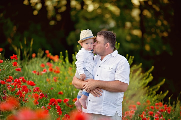 Father and son at sunset in poppy field