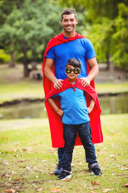 Photo father and son in superhero costume