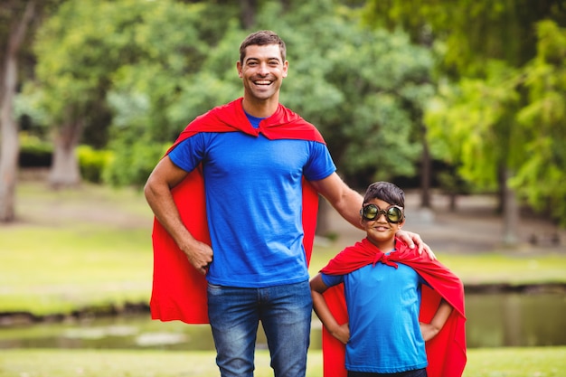 Photo father and son in superhero costume