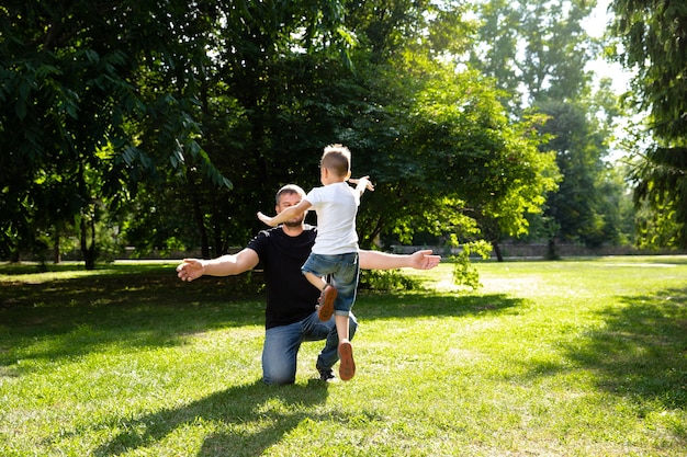 Father and son together in park playing