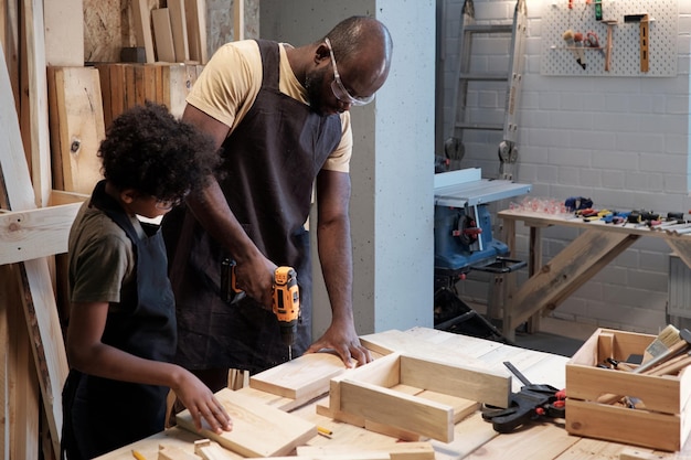 Father and son together in workshop