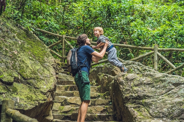 Father and son tourists go down the stairs