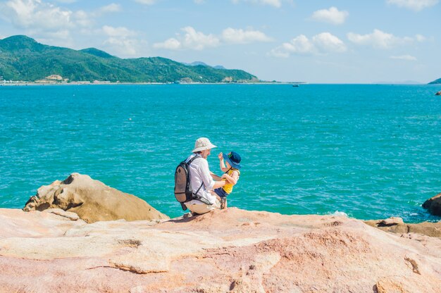 Father and son travelers at the Hon Chong cape, Garden stone, popular tourist destinations at Nha Trang. Vietnam