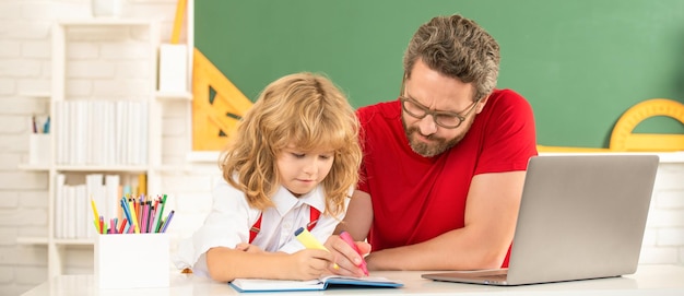 Father and son use modern communication technology in classroom family blog