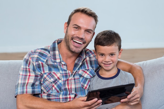 Father and son using digital tablet