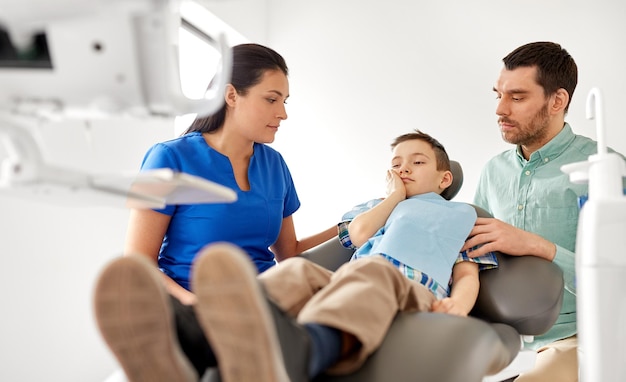 father and son visiting dentist at dental clinic