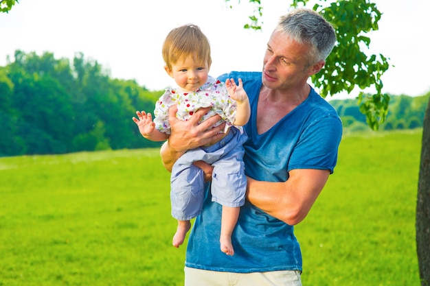 Father and son on a walk kid in the hands of his father