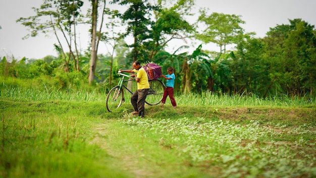 Father and son walking in farm image