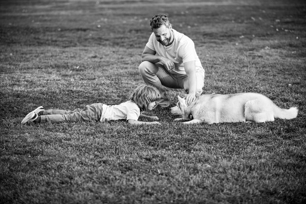 Father and son with pet dog on nature