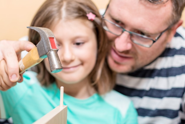 Father and sons are are building the furniture at home