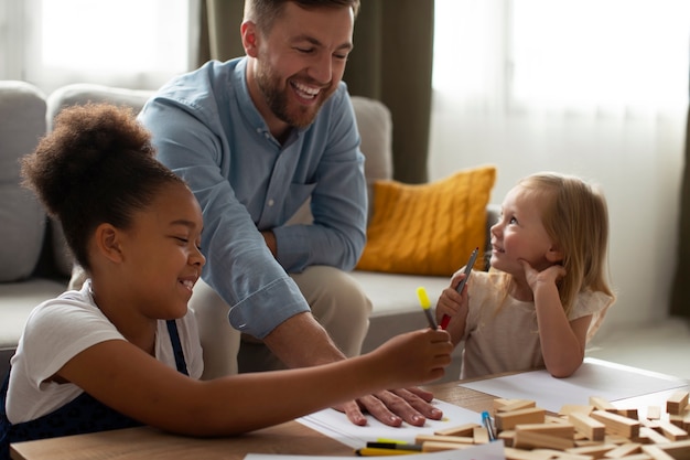 Photo father spending time with his adopted daughters