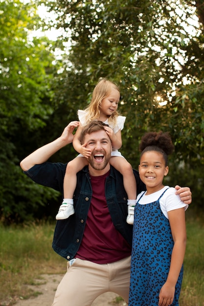 Photo father spending time with his adopted daughters