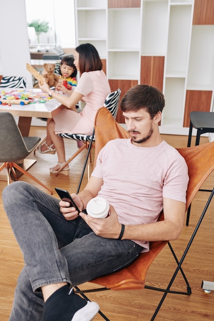 Father spending time with smartphone