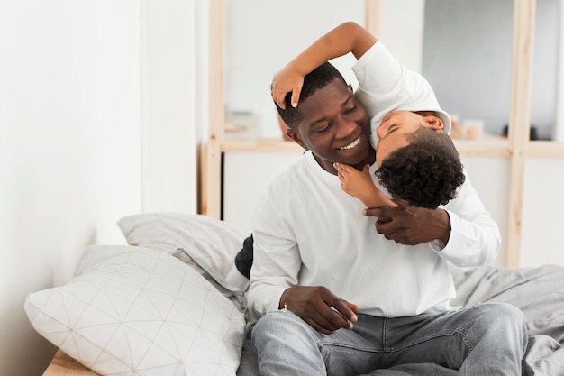 Father and sun playing indoors