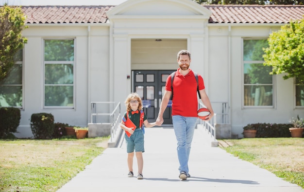 Father supports and motivates son kid going to primary school