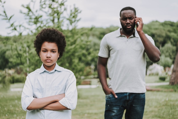 Father Talking on Phone and Boy Turned Away.