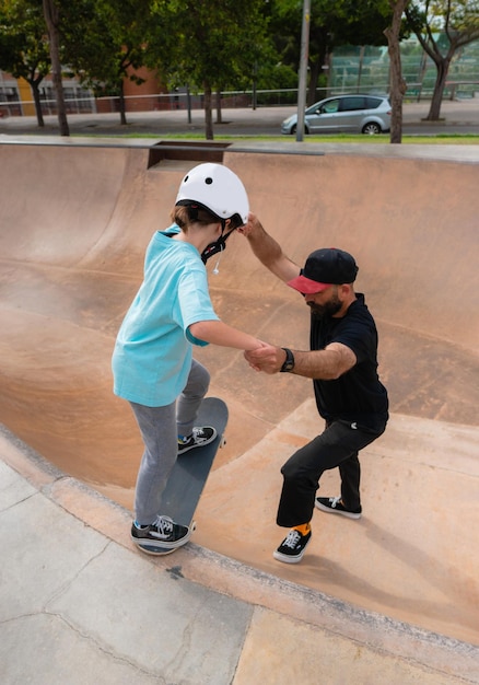 Father teaches daughter to skate