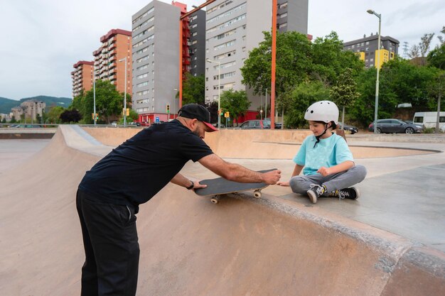 Father teaches daughter to skate