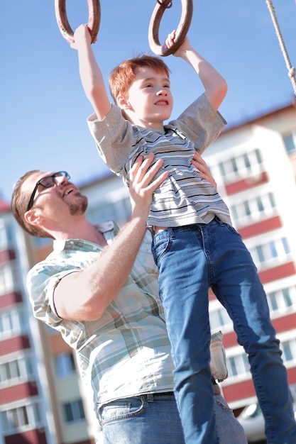 Father teaches his son to catch up on the bar