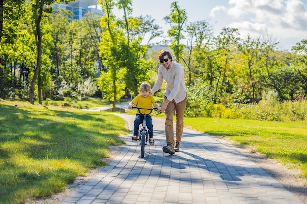 Father teaches his son ride a bicycle