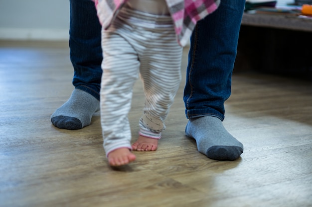 Father teaching a baby to walk