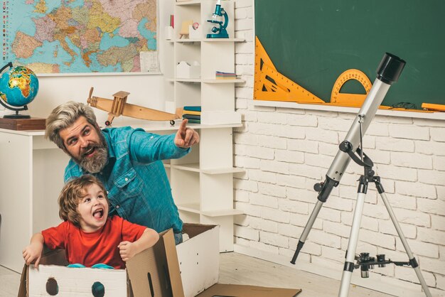 Father teaching son Astronomy Cute pupil and his father schooling work