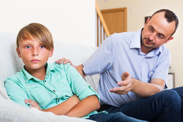 Photo father and teenage son argue