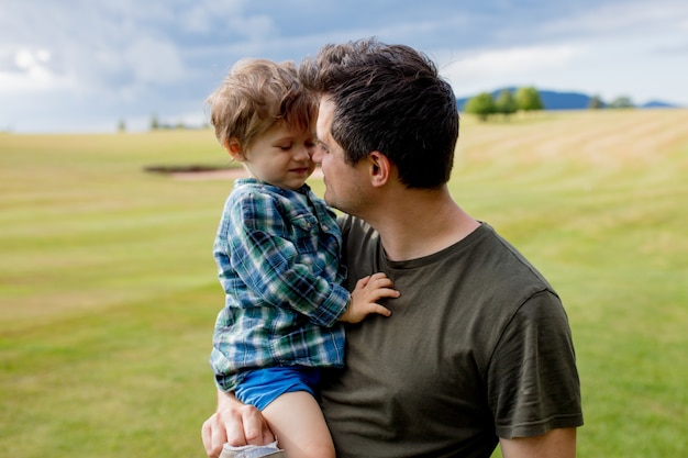 Father and toddler boy have a fun in a mountains