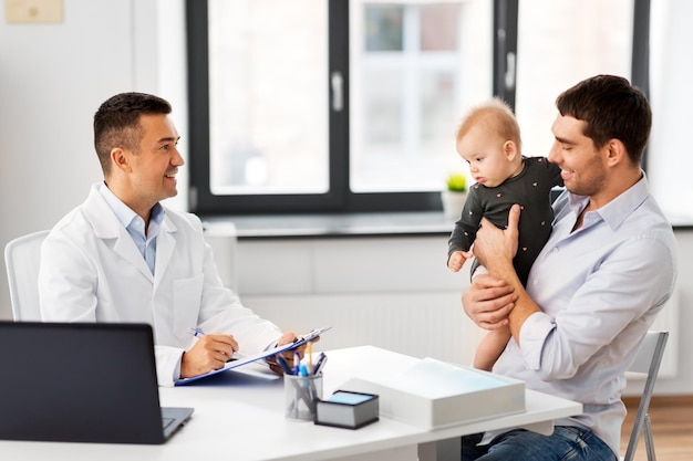 father with baby and doctor at clinic