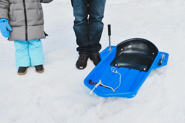 A father with child sledding in the snow