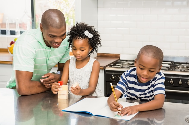 Father with children in the kitchen at home