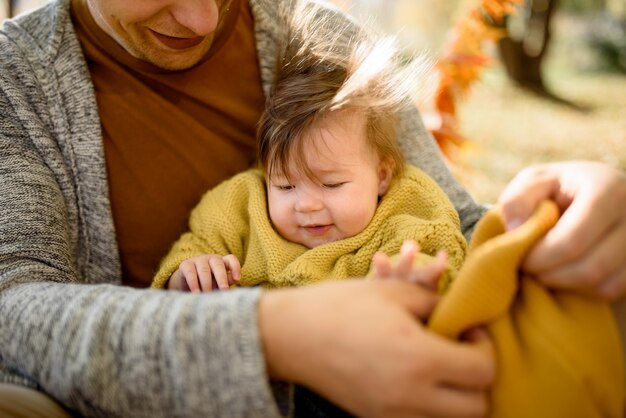 A father with daughter baby in autumn forest