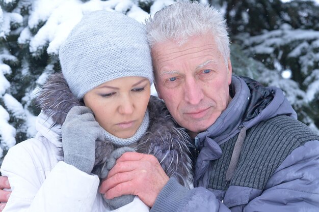 Father with daughter posing outdoors in winter