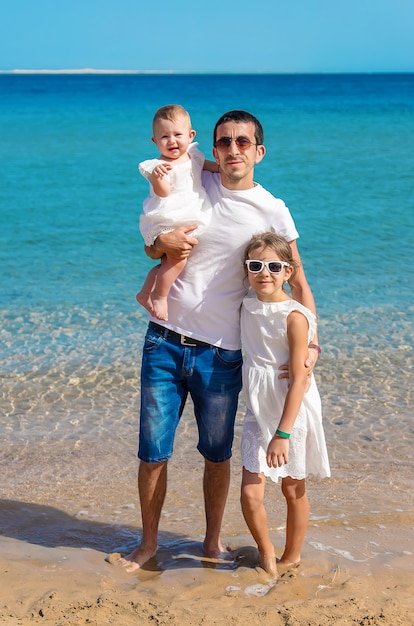 Father with daughters at sea